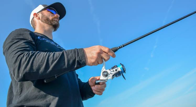 A close-up of a modern spinning reel and rod setup ready to cast